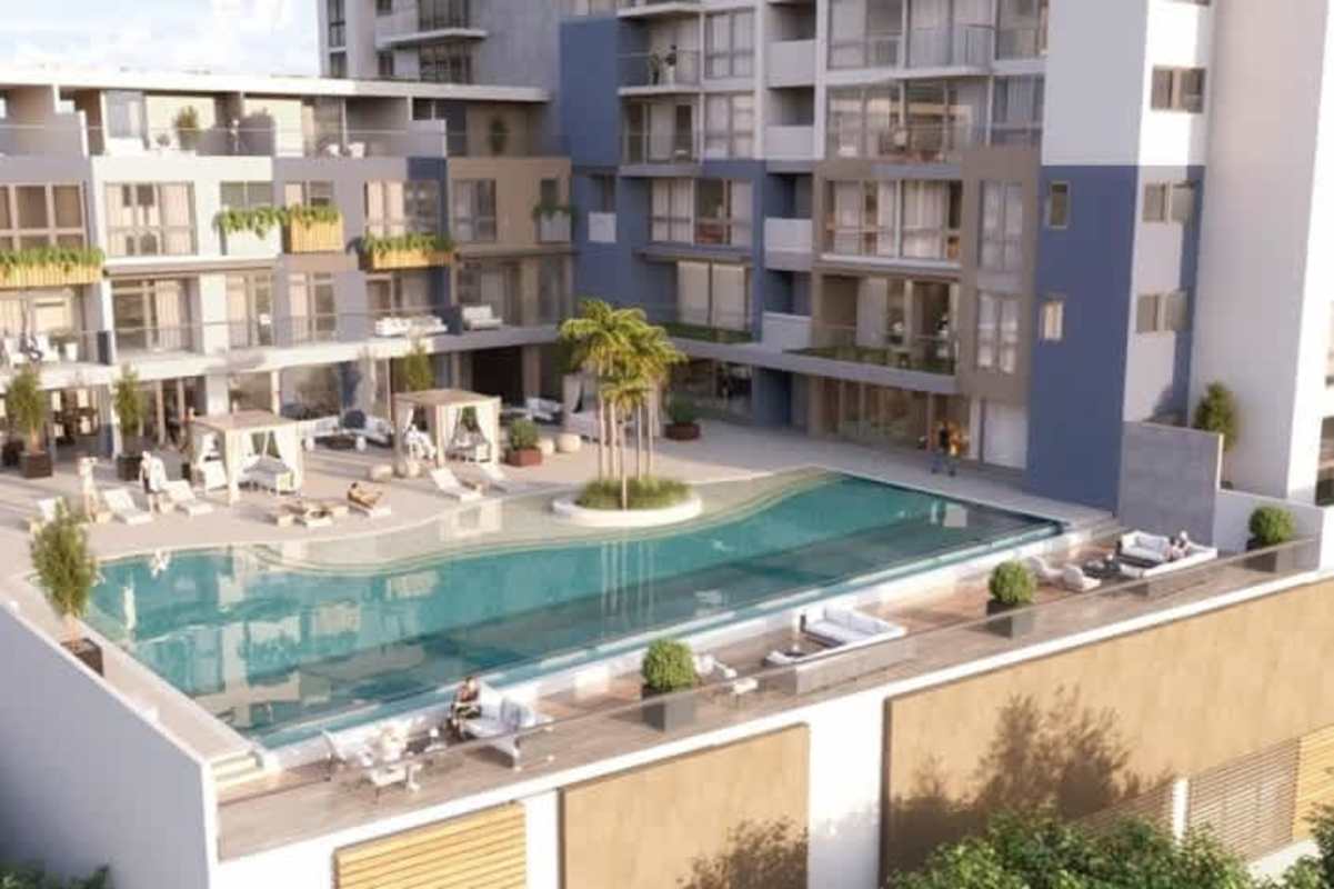 Aerial view rooftop swimming pool, loungers and greenery at Oceana Santa Maria Panama