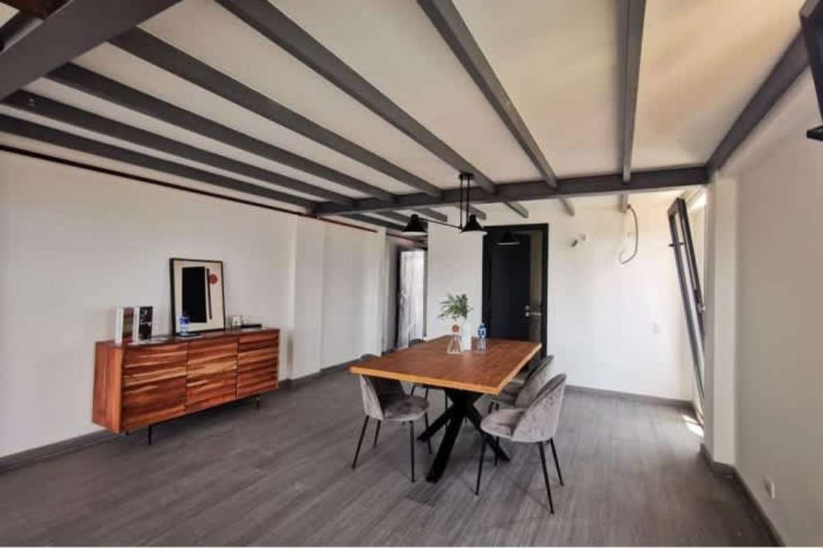 Spacious two-level loft apartment with floor-to-ceiling insulated windows at PH Urban Loft Panama City