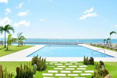 Spacious bedroom with oceanfront balcony access in Royal Palm Playa Gorgona Panama