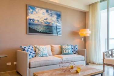 Bright living room with oceanfront views and balcony access at Royal Palm Gorgona Panama