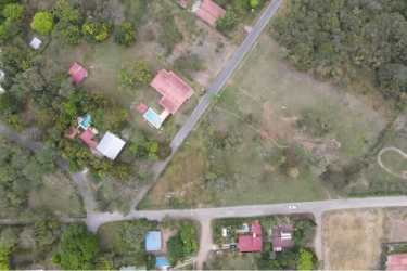 Suburban rural neighborhood with open lots, homes, vegetation near ocean Gorgona