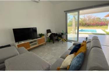 Bedroom with bunk beds large window ceiling fan in La Mare Punta Barco beach house Panama