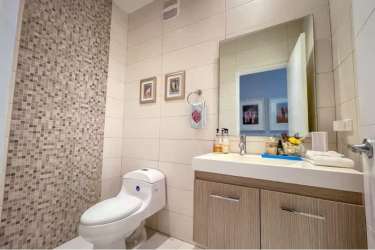 Luxury bathroom with designer tile and glass shower in Bijao condo Panama