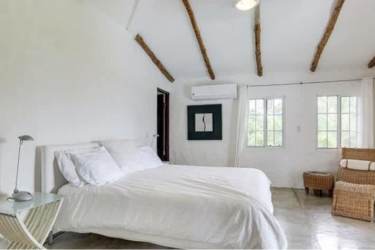 Bright bedroom with balcony exposed beams vaulted ceiling PH El Cortijo Costa Esmeralda Panama
