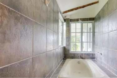 Rustic double-height open living area stone accent wall inside Costa Esmeralda villa Panama
