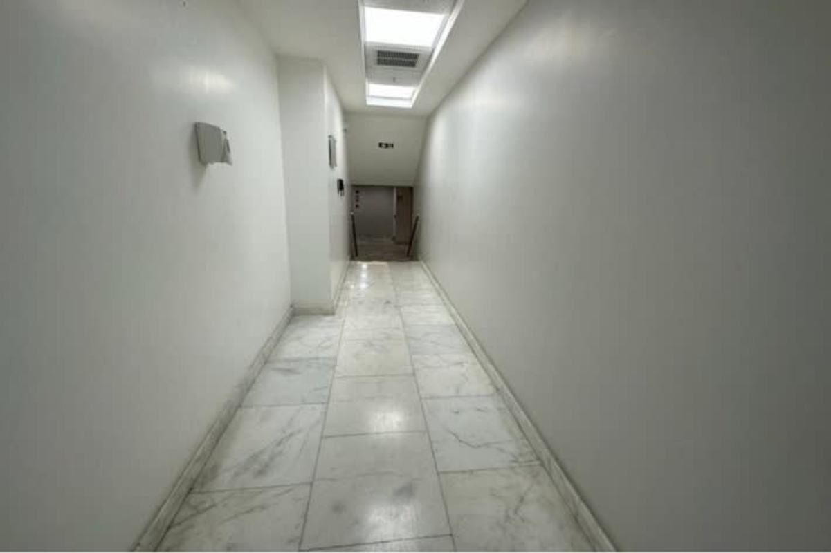 Empty modern office space with glass walls and tile flooring at Hi Point Offices Panama City