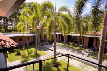 Lush tropical landscaped courtyard with palm trees Buenaventura