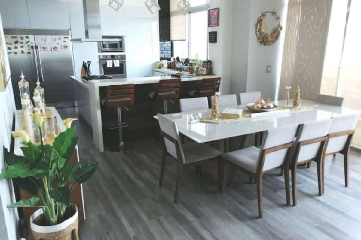 Glass-railing balcony with potted plants overlooking city skyline in Dos Mares Betania Panama