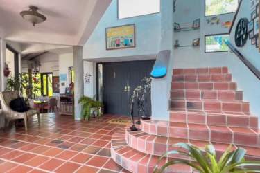 Rustic bedroom with terracotta tiles, garden views, twin beds, luxury home Panama