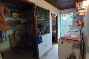 Living room with stone finish, sofa and ceiling fan in commercial house for sale David Chiriquí