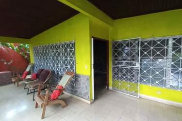 Large covered porch with seating, metal grilles and tiled floor of commercial house in David Chiriquí