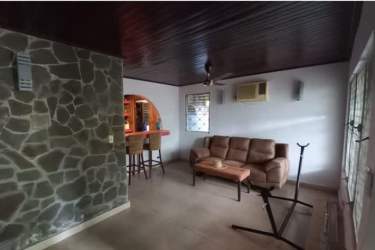 Laundry room with washer dryer and storage shelves in central commercial home David Chiriquí