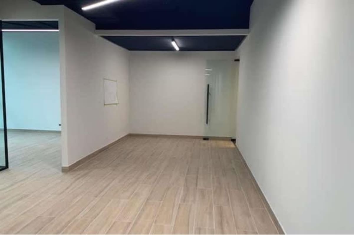 Large open office space with windows and recessed lights in Tower Bank Panama