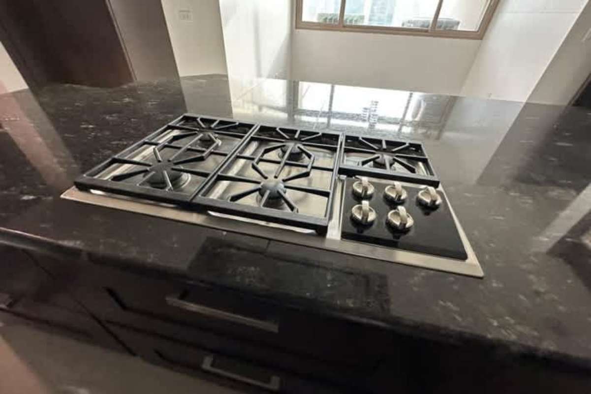 Large open plan dining and living room with marble floors and balcony access in Pacific Point Tower 200 Panama City