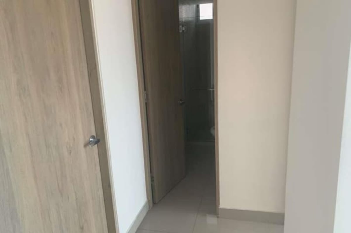 Bathroom featuring glass shower enclosure, wood-textured tiles, and double sinks at PH Zaphiro Panama