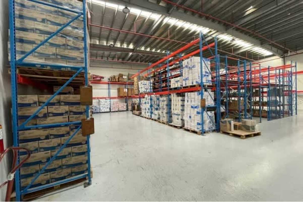 Spacious warehouse with shelving racks and concrete floors at Panama Viejo Business Center Panama