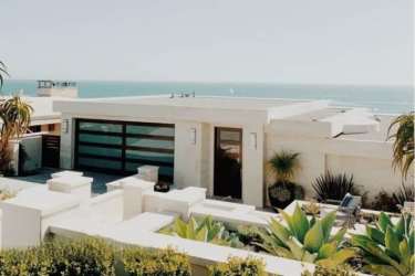 Modern beachfront villa with private pool, palm trees and lounge chairs at Rio Hato Panama