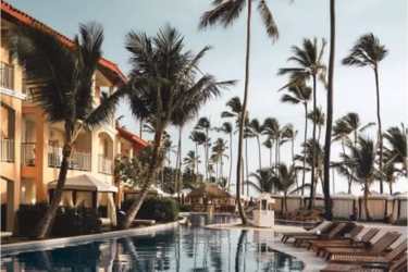 Mediterranean style beachfront resort pool with palm trees and cabanas at Rio Hato Panama