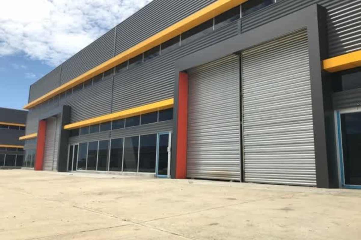 Wide roller shutter industrial doors elevated dock area at modern warehouse in Panama