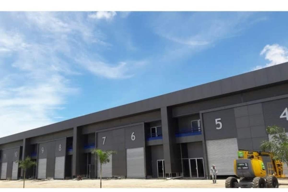 Landscaped frontage of commercial warehouse complex with palm trees Las Mañanitas Panama City