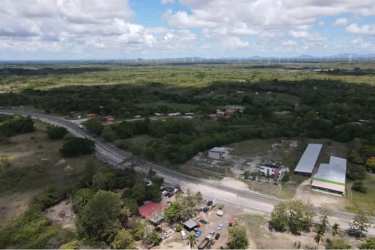 Wide aerial view including warehouse, office building and surrounding countryside Penonomé