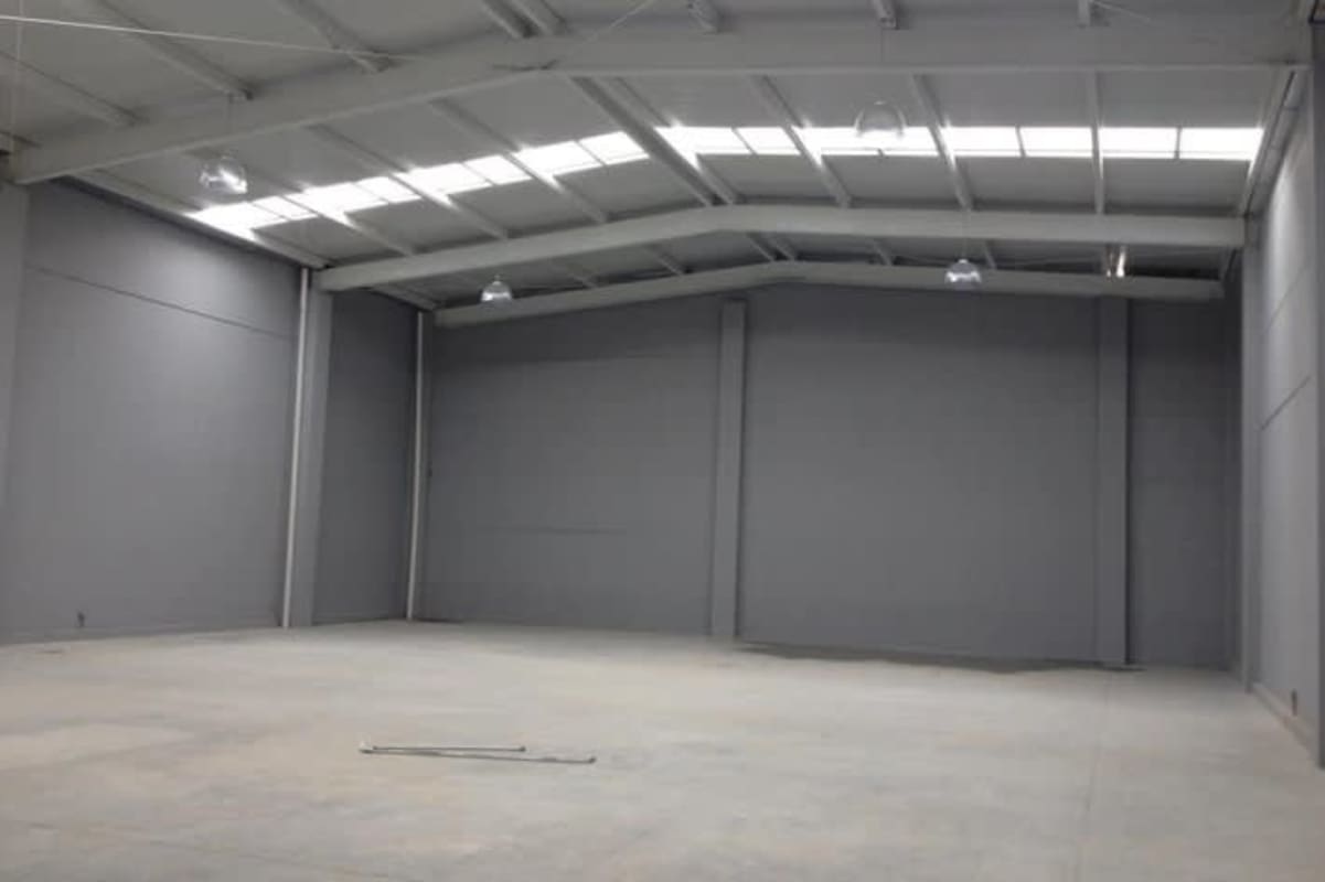 Spacious empty warehouse interior with high ceiling and mezzanine in Tocumen Panama