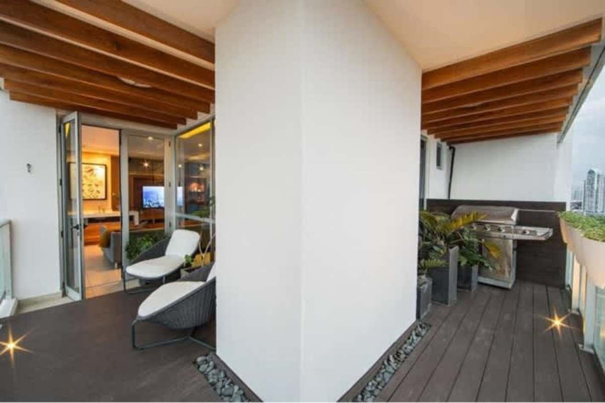 Spacious open plan living area with sectional sofa modern kitchen PH Oceanaire Panama City