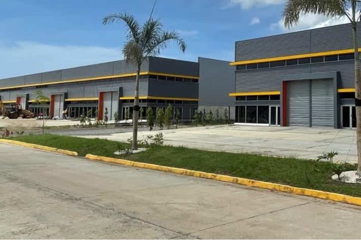 Palm trees and green landscaped gardens at entrance of modern industrial warehouse park Juan Díaz Panama