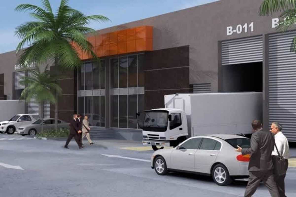 Loading dock area with delivery trucks parking palm trees sidewalk at modern warehouse industrial complex Panama City
