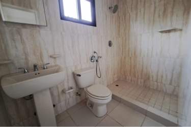 Contemporary open kitchen with dark cabinets, breakfast bar, lights, tile floor Summer Hills Costa Verde