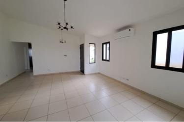 Spacious master bedroom with tile floors, large window, bathroom access in Summer Hills Costa Verde Panama