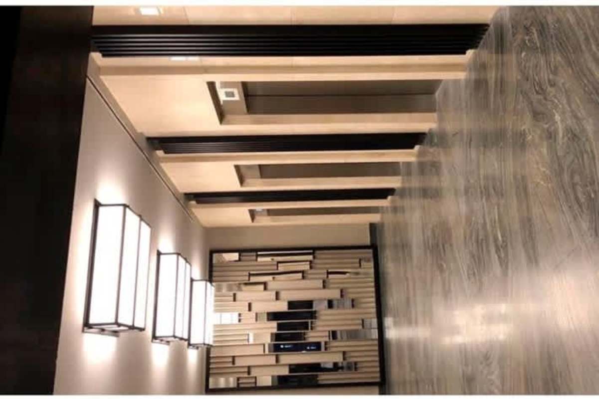 Modern hallway with geometric wall designs and lighting PH Panama Business Tower