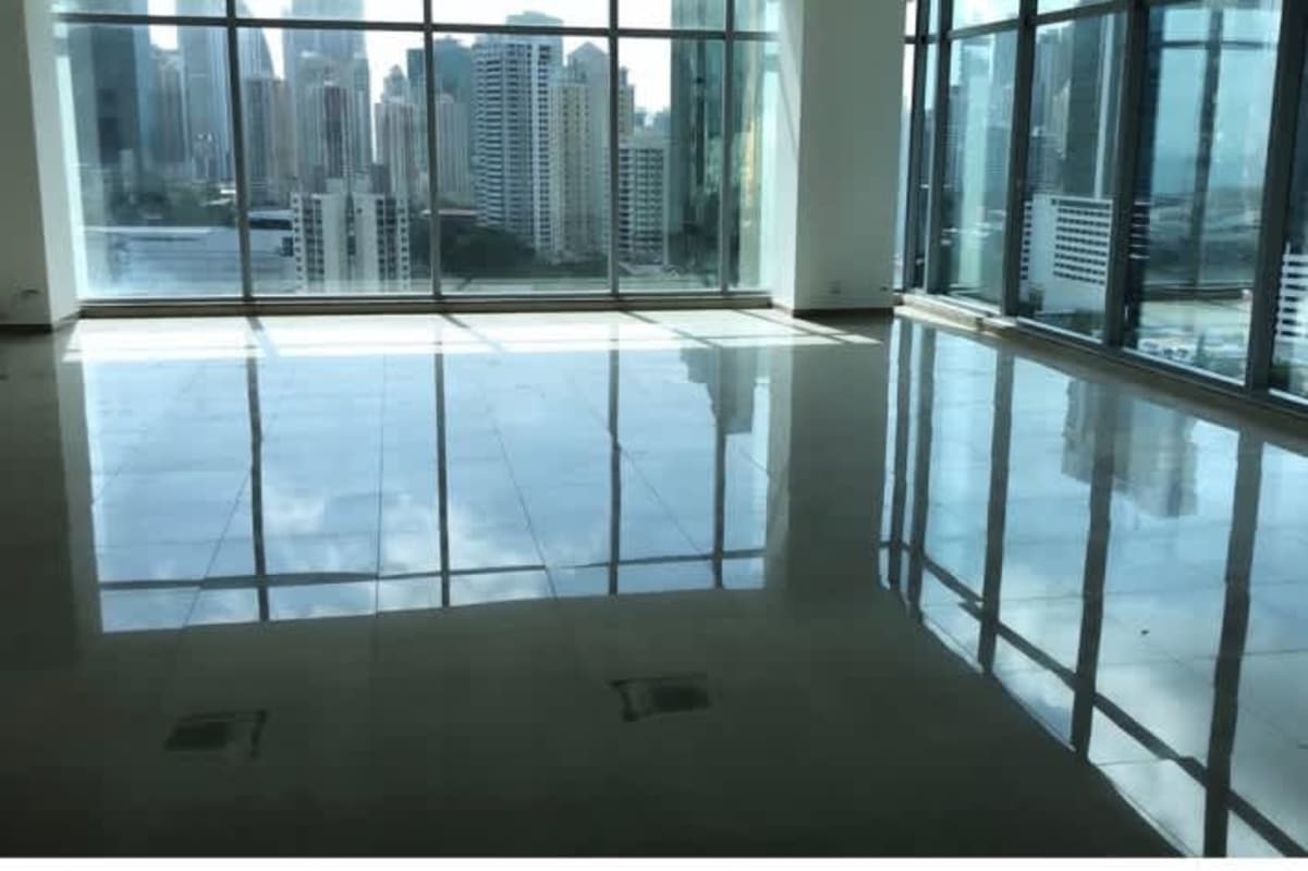 Elegant office lobby with marble floors, bookshelf divider, reception lounge and lighting in Panama Business Tower Obarrio