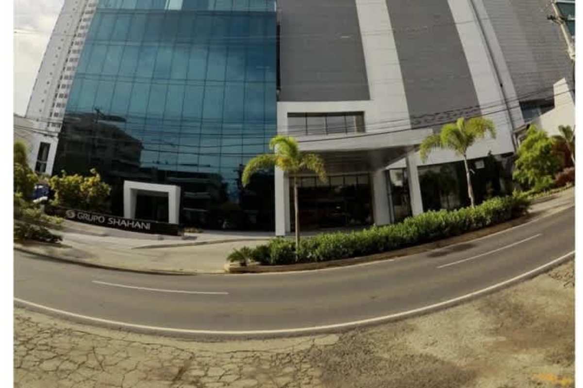 Covered entrance with landscaped greenery and modern canopy at PH Panama Business Tower Panama City