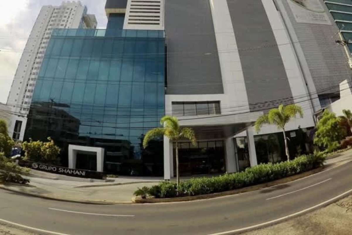 Glass facade premium corporate skyscraper with landscaped entry Panama Business Tower Obarrio Panama
