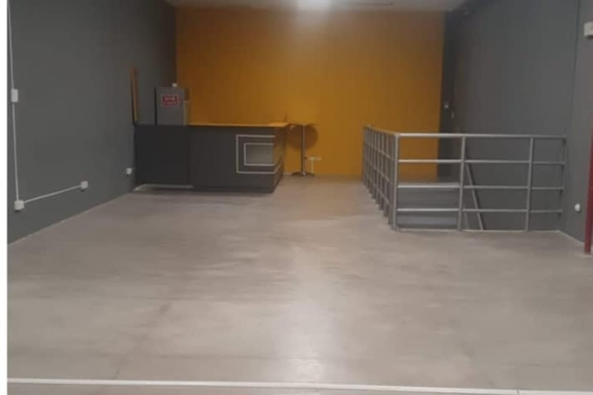 Office or reception area with grey and yellow walls, metal staircase and desk Plaza Obarrio Panama