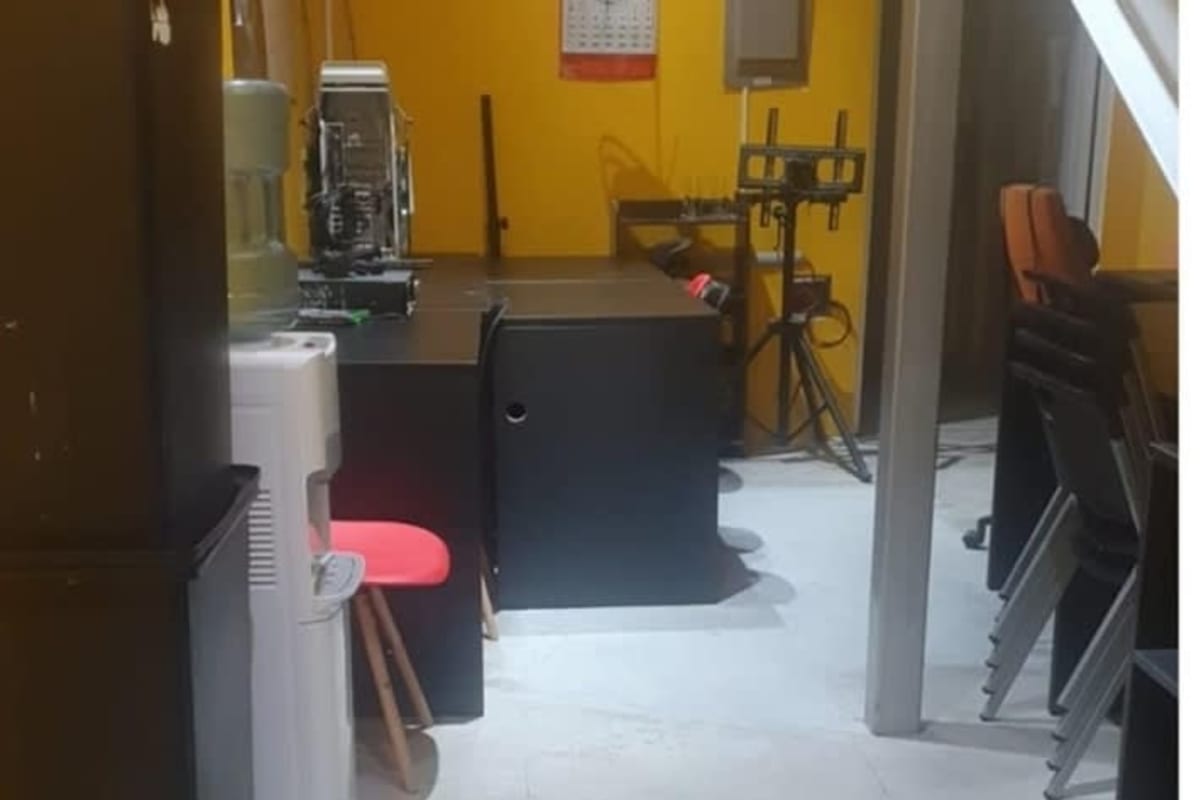 Workspace section with yellow walls, desks, chairs and equipment in Plaza Obarrio Panama City