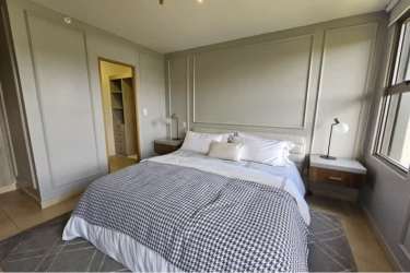 Bright bedroom with large window built-in closet modern design PH Parterre Panama Pacifico