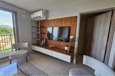 Stylish living room with entertainment wall, floating console, and large window in PH Madeira Panama Pacifico