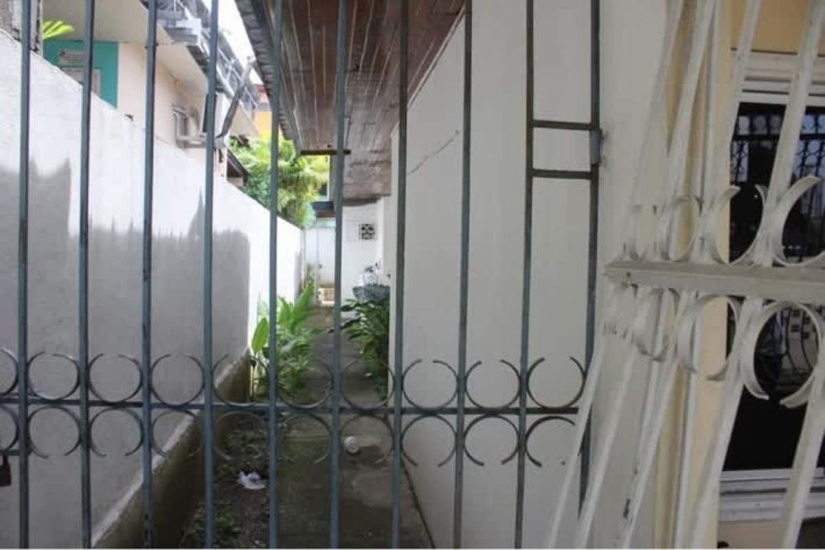 Front driveway with gated entry, barred windows, mature landscaping Betania commercial house