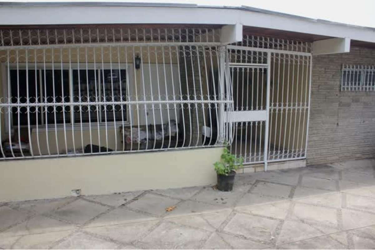 Covered porch with metal security bars, tiled patio, stone facade Betania business rental