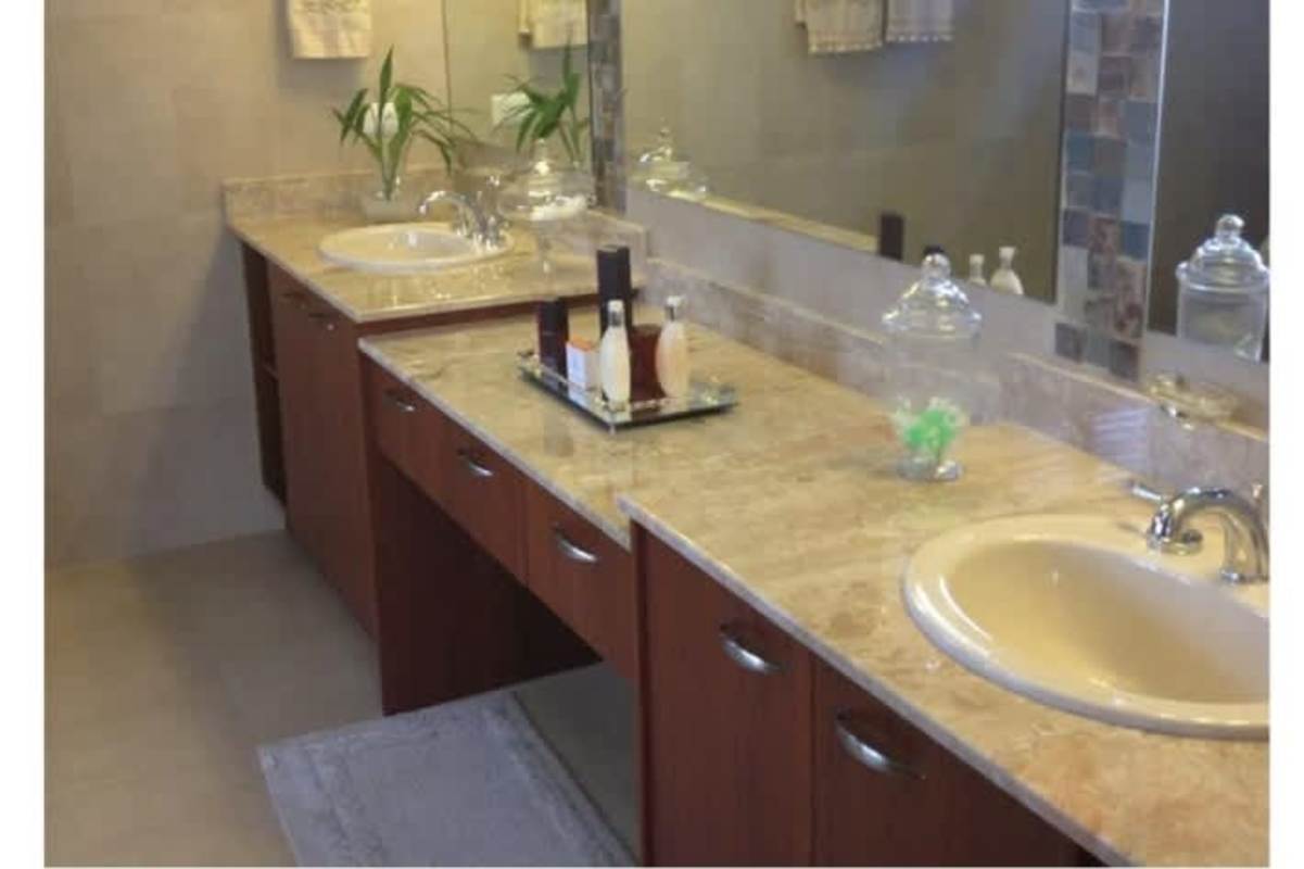 Modern bathroom with marble vanity and double sinks in house at El Doral Costa Sur Panama