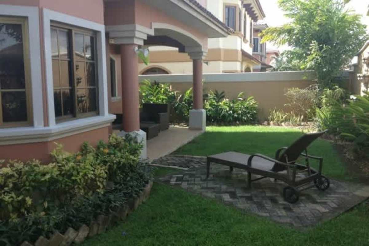Aerial panorama of El Doral Costa Sur Panama housing development with red-tiled roofs and green areas