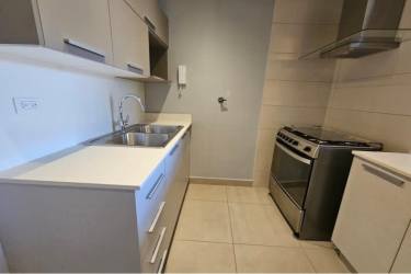 Galley kitchen with stainless steel appliances and light cabinetry PH Madeira Panama Pacifico