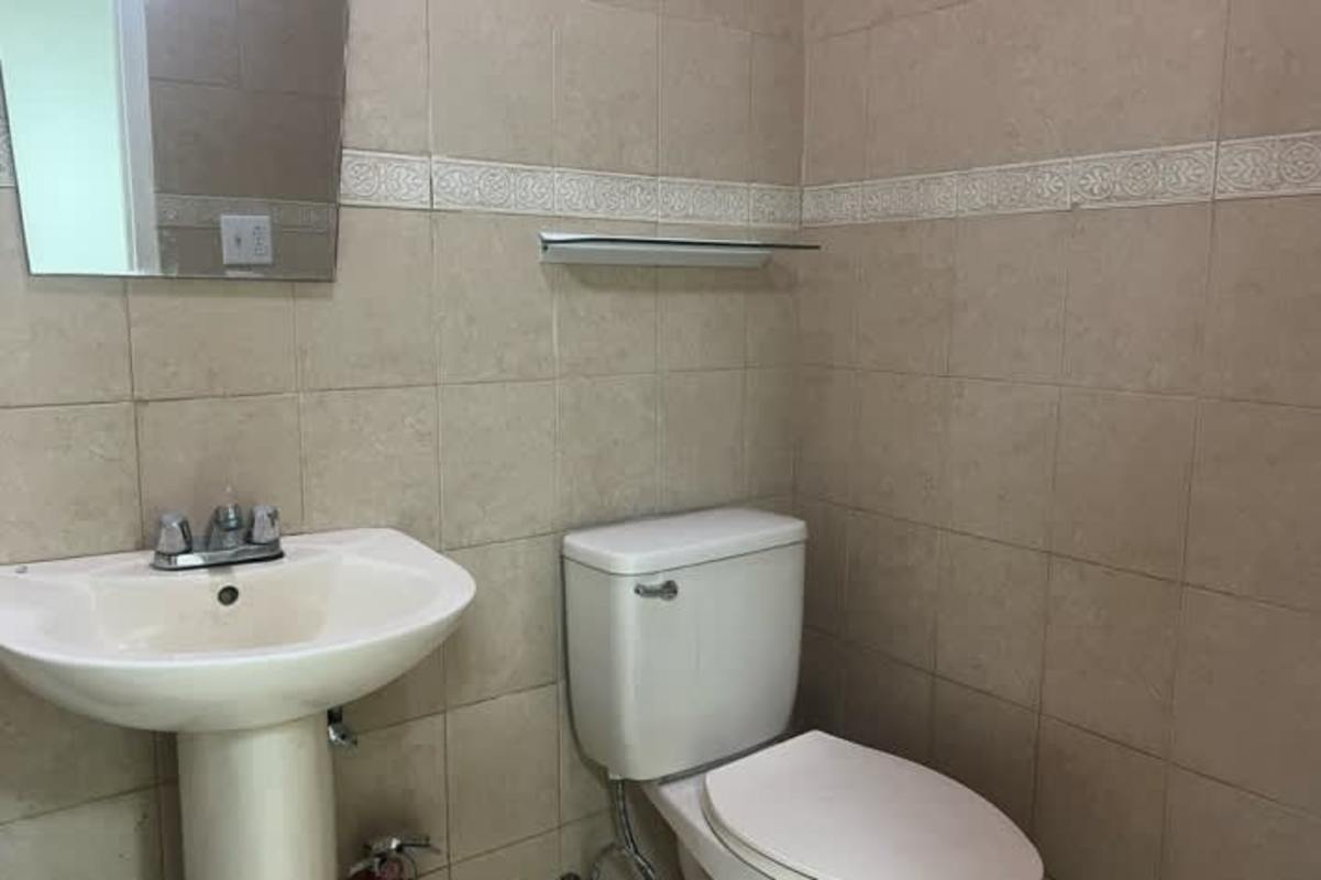 Unfurnished office for rent in PanCanal Plaza with wood-look tile floors and LED lighting