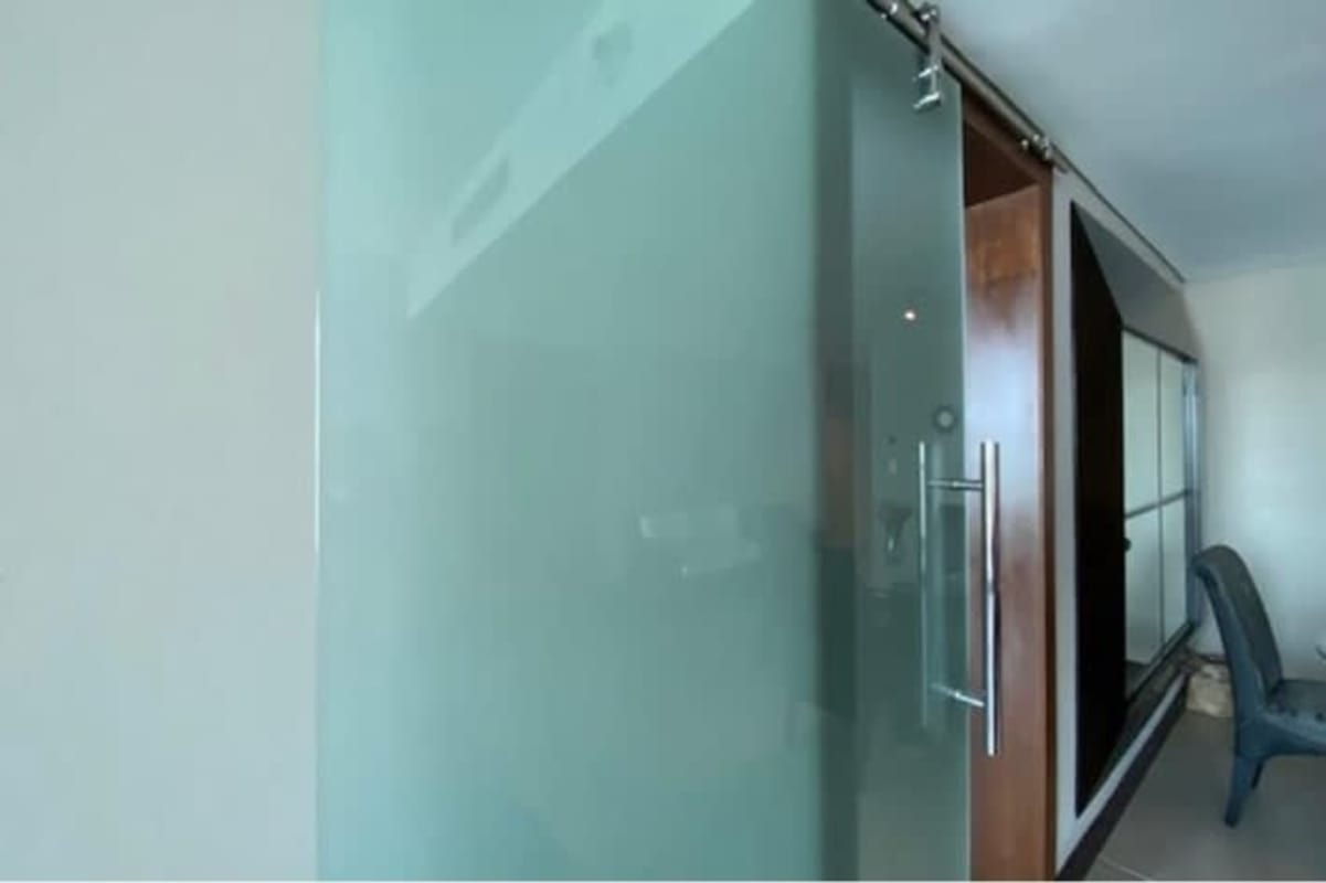 Glass railing balcony overlooking ocean skyline PH Megapolis apartment Panama