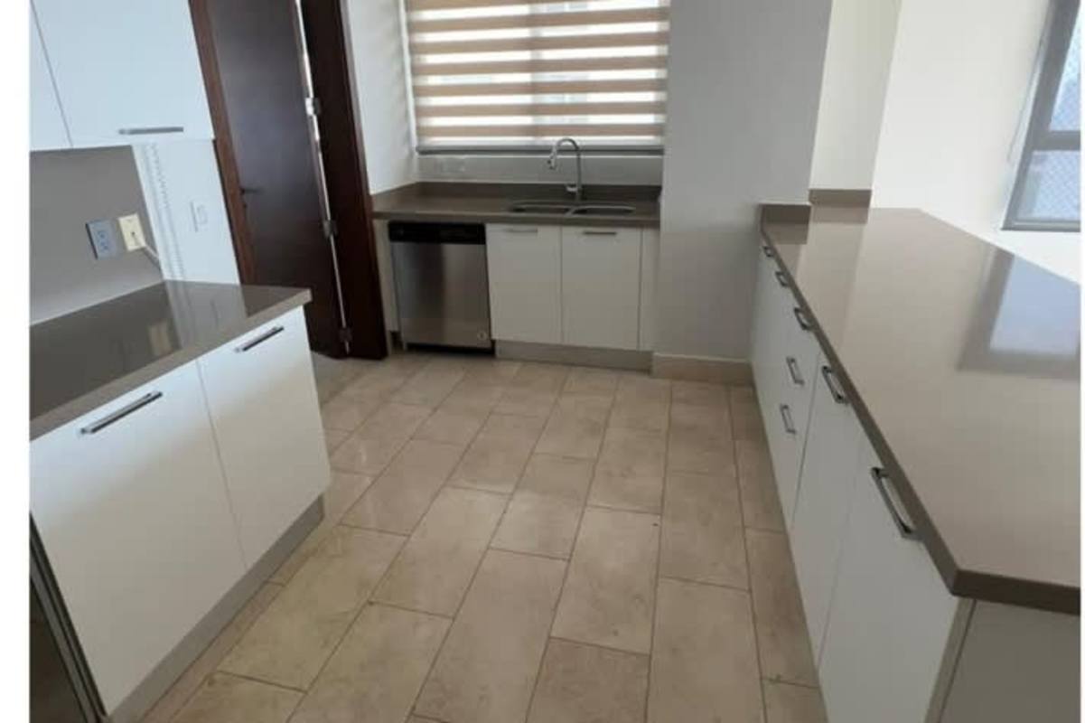 Contemporary kitchen with white cabinetry and quartz countertops at PH Green View Santa María Panama