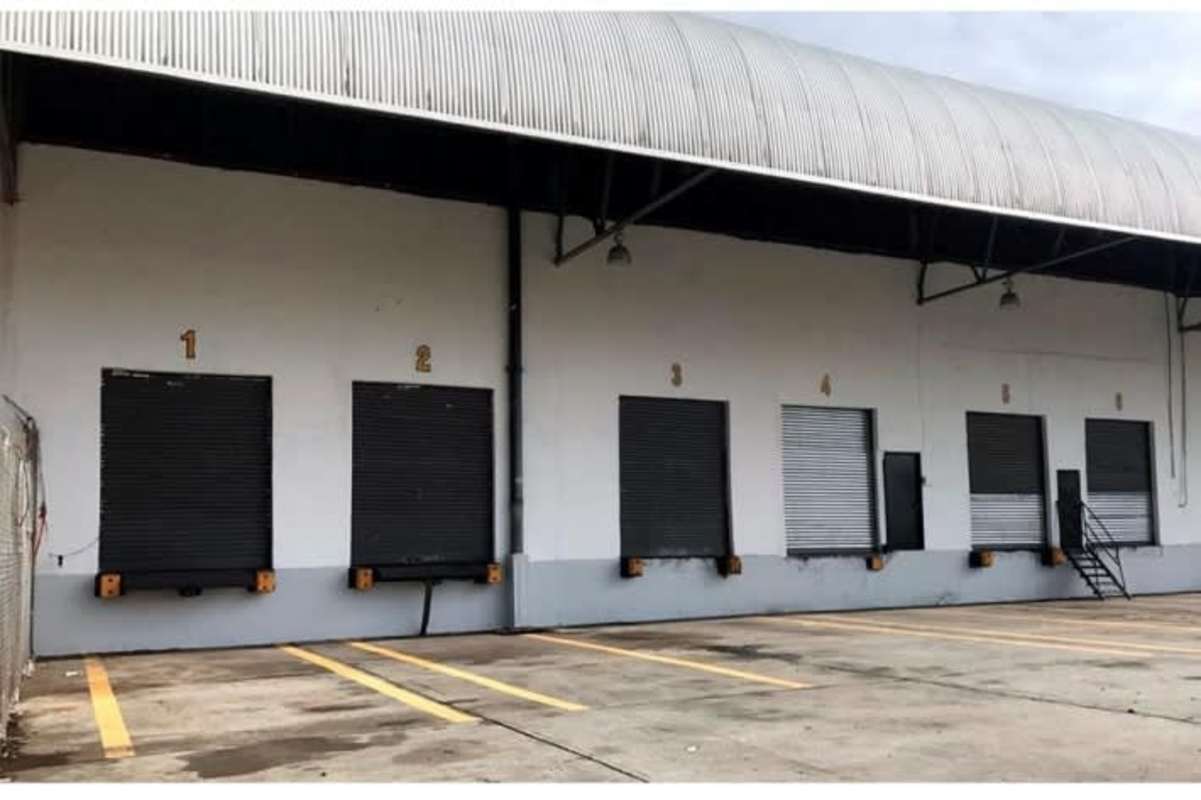 Warehouse exterior with loading bays and truck docks in industrial park Panama City