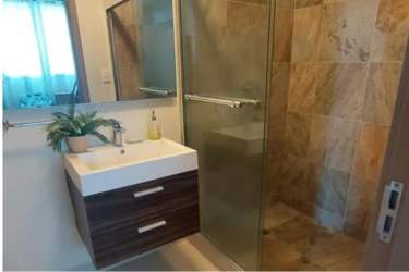 Kitchen with granite counters, built-in oven and modern appliances in PH Ensenada San Carlos