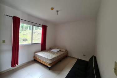 Rustic balcony with wood railing overlooking lush forest Altos del María Panama